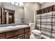 Bathroom featuring a gray countertop, mirror, toilet and a shower with a patterned curtain at 1513 Tottenham Dr, Danville, IN 46122