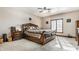 Comfortable bedroom features carpet flooring, a ceiling fan, and a large bed at 1513 Tottenham Dr, Danville, IN 46122