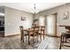 Sunlit dining area featuring a classic table set, stylish decor, and neutral wall paint at 1513 Tottenham Dr, Danville, IN 46122