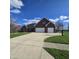 Beautiful brick home boasts a long driveway, two-car garage, and well-maintained lawn at 1513 Tottenham Dr, Danville, IN 46122