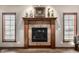 Close up view of the living room fireplace with an ornate wood mantle and tile surround at 1513 Tottenham Dr, Danville, IN 46122