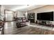 Spacious living room with wood floors, a large TV, and comfortable leather seating at 1513 Tottenham Dr, Danville, IN 46122