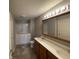 Bathroom featuring double sinks, tile floor, and accessible walk-in shower at 1623 Senior Ct, Shelbyville, IN 46176