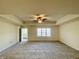 Carpeted primary bedroom featuring tray ceiling, neutral walls, and ample natural light at 1623 Senior Ct, Shelbyville, IN 46176