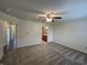 Spacious bedroom features neutral carpet, ceiling fan, and convenient access to an ensuite bathroom at 1623 Senior Ct, Shelbyville, IN 46176
