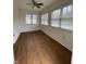 Sunlit bedroom showcasing a ceiling fan, wood flooring, and bright windows at 1623 Senior Ct, Shelbyville, IN 46176