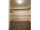Walk-in closet featuring neutral carpeting, white walls, and wooden shelves at 1623 Senior Ct, Shelbyville, IN 46176