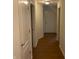 Hallway with modern wood flooring and neutral paint leading to various rooms at 1623 Senior Ct, Shelbyville, IN 46176