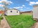 Well-maintained backyard features lush green grass, an air conditioner, and neighborhood views at 1816 N Moreland Ave, Indianapolis, IN 46222
