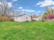 Lush backyard with a detached garage and shed, all bordered by a wooden fence at 1816 N Moreland Ave, Indianapolis, IN 46222