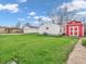 Spacious backyard with detached garage, shed, and manicured lawn at 1816 N Moreland Ave, Indianapolis, IN 46222