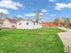 Expansive backyard featuring green grass, a detached garage, and a church view at 1816 N Moreland Ave, Indianapolis, IN 46222