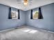 This bedroom features neutral carpeting, light blue walls and a ceiling fan at 1816 N Moreland Ave, Indianapolis, IN 46222