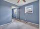 This bedroom features neutral carpeting, light blue walls and a sliding mirror door closet at 1816 N Moreland Ave, Indianapolis, IN 46222