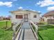 Charming single-story home with a well-manicured lawn and inviting front porch and white picket fence at 1816 N Moreland Ave, Indianapolis, IN 46222