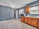 Kitchen featuring tile floors and wooden cabinets, with ample natural light from the window at 1816 N Moreland Ave, Indianapolis, IN 46222