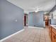 Spacious kitchen with tile flooring and wooden cabinets, adjacent to the living area at 1816 N Moreland Ave, Indianapolis, IN 46222