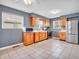 Well-lit kitchen featuring stainless steel appliances, warm wood cabinets, and tile floors at 1816 N Moreland Ave, Indianapolis, IN 46222