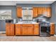 Functional kitchen with wooden cabinets, stainless steel oven, tile flooring, and natural light at 1816 N Moreland Ave, Indianapolis, IN 46222