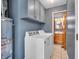 This laundry room features ample storage, a modern washer and dryer, and access to a half bathroom at 1816 N Moreland Ave, Indianapolis, IN 46222
