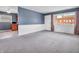 Bright living room with tile flooring that transitions to a cozy carpeted area and natural light at 1816 N Moreland Ave, Indianapolis, IN 46222