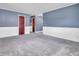 Comfortable living room with neutral carpet, blue walls and plenty of space at 1816 N Moreland Ave, Indianapolis, IN 46222
