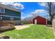 Green backyard featuring a deck, seating area, and convenient access to a detached garage at 2018 Cornell Ave, Indianapolis, IN 46202