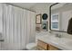 Bright bathroom featuring decorative wall art, white patterned shower curtain, and modern fixtures at 2018 Cornell Ave, Indianapolis, IN 46202