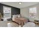 Bedroom with a board and batten accent wall, two windows, and a plush rug at 2018 Cornell Ave, Indianapolis, IN 46202