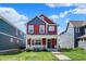 Charming two-story home with red siding, blue accents, and a welcoming front porch at 2018 Cornell Ave, Indianapolis, IN 46202
