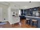 Stylish kitchen featuring dark cabinetry, stainless steel appliances, and a breakfast bar at 2018 Cornell Ave, Indianapolis, IN 46202