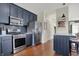 Contemporary kitchen with stainless steel appliances, a breakfast bar and hardwood floors at 2018 Cornell Ave, Indianapolis, IN 46202