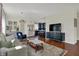 Open-concept living room flows into kitchen, featuring hardwood floors and modern decor at 2018 Cornell Ave, Indianapolis, IN 46202