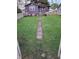 Spacious backyard with well-maintained grass and a charming concrete path at 213 S Brittain Ave, Muncie, IN 47303