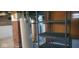 Utility area in basement featuring hot water heater, brick foundation, and plastic shelving at 213 S Brittain Ave, Muncie, IN 47303