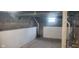 Unfinished basement space with block foundation and small window for natural light at 213 S Brittain Ave, Muncie, IN 47303