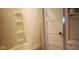Clean bathroom featuring a tub, shower, door, toilet and shelving unit at 213 S Brittain Ave, Muncie, IN 47303