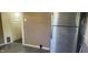 Functional kitchen with stainless steel refrigerator and a pass-through to another room at 213 S Brittain Ave, Muncie, IN 47303