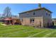 A view of the backyard with the patio, landscaping and brick and vinyl siding at 2328 Discovery Dr, Anderson, IN 46017