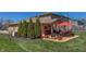 Patio with an orange umbrella, chairs, and brick exterior, offering a perfect space for relaxing and entertaining at 2328 Discovery Dr, Anderson, IN 46017