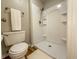 Bathroom featuring a shower unit with bronze shower head, toilet and a white plush rug at 2328 Discovery Dr, Anderson, IN 46017