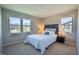 Bright bedroom featuring plush carpet, fresh paint, and natural light from two large windows at 2328 Discovery Dr, Anderson, IN 46017
