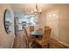 Well-lit dining area with a round table, seating for four, and an open view to the kitchen at 2328 Discovery Dr, Anderson, IN 46017