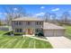 Beautiful two-story home features brick accents, a manicured lawn, and an attached two car garage at 2328 Discovery Dr, Anderson, IN 46017