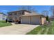 Two-story home with brick accents and two-car garage at 2328 Discovery Dr, Anderson, IN 46017