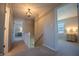 Upstairs hallway with staircase, neutral carpet, and view of bedrooms and landing at 2328 Discovery Dr, Anderson, IN 46017