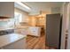 Well-lit kitchen featuring white cabinets and view into the dining room at 2328 Discovery Dr, Anderson, IN 46017