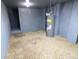 Basement featuring gravel floor and water heater, providing a utilitarian space for storage and mechanical systems at 249 E Minnesota St, Indianapolis, IN 46225