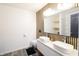 Bathroom featuring a floating vanity, wood accent wall, and dual vessel sinks at 249 E Minnesota St, Indianapolis, IN 46225