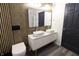 This updated bathroom features a floating vanity, wood accent wall, and dual sinks at 249 E Minnesota St, Indianapolis, IN 46225